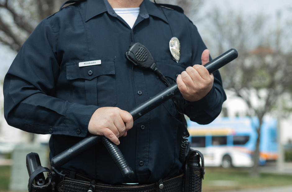 Man in Black Police Uniform Holding Black Metal Rod