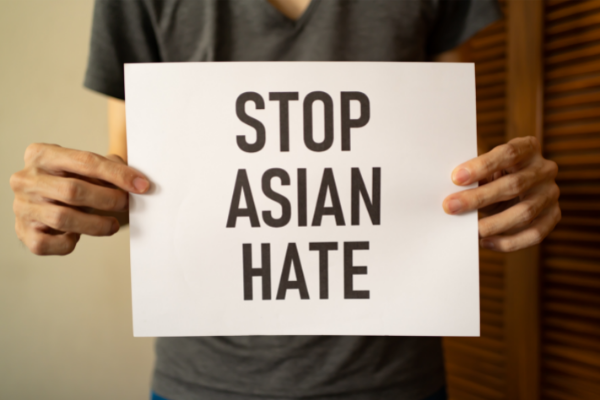 A man holding Stop Asian Hate sign